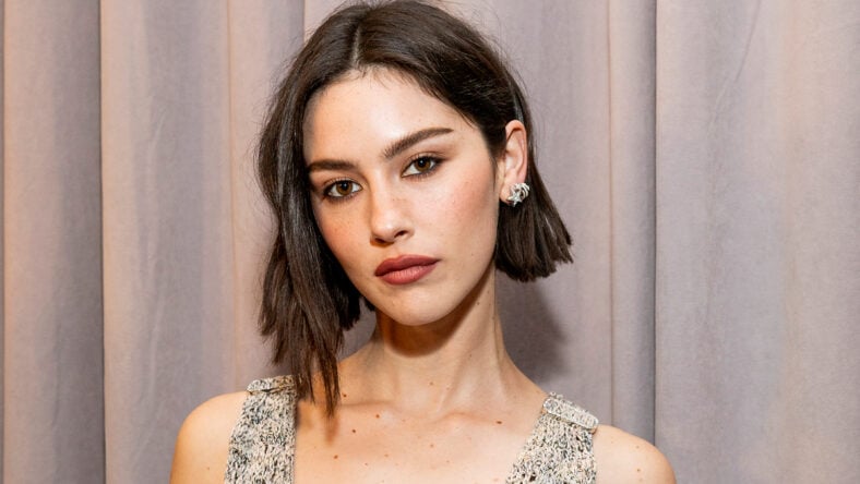 Gracie Abrams poses for a close-up portrait at the 2025 Grammys, wearing a sleeveless textured dress with her short dark hair styled in a bob.