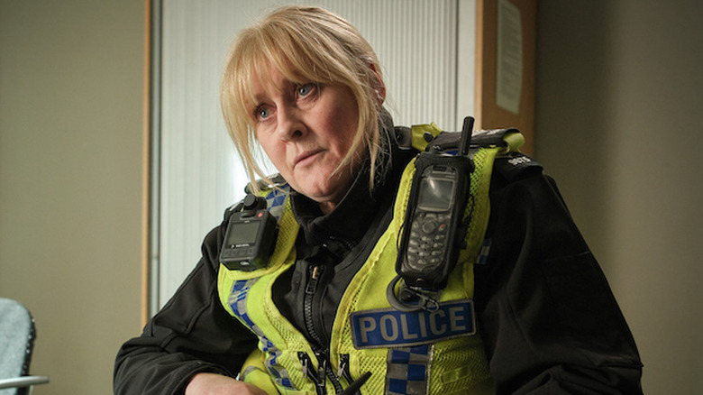 Catherine Cawood (Sarah Lancashire) looks up from writing a form in Happy Valley