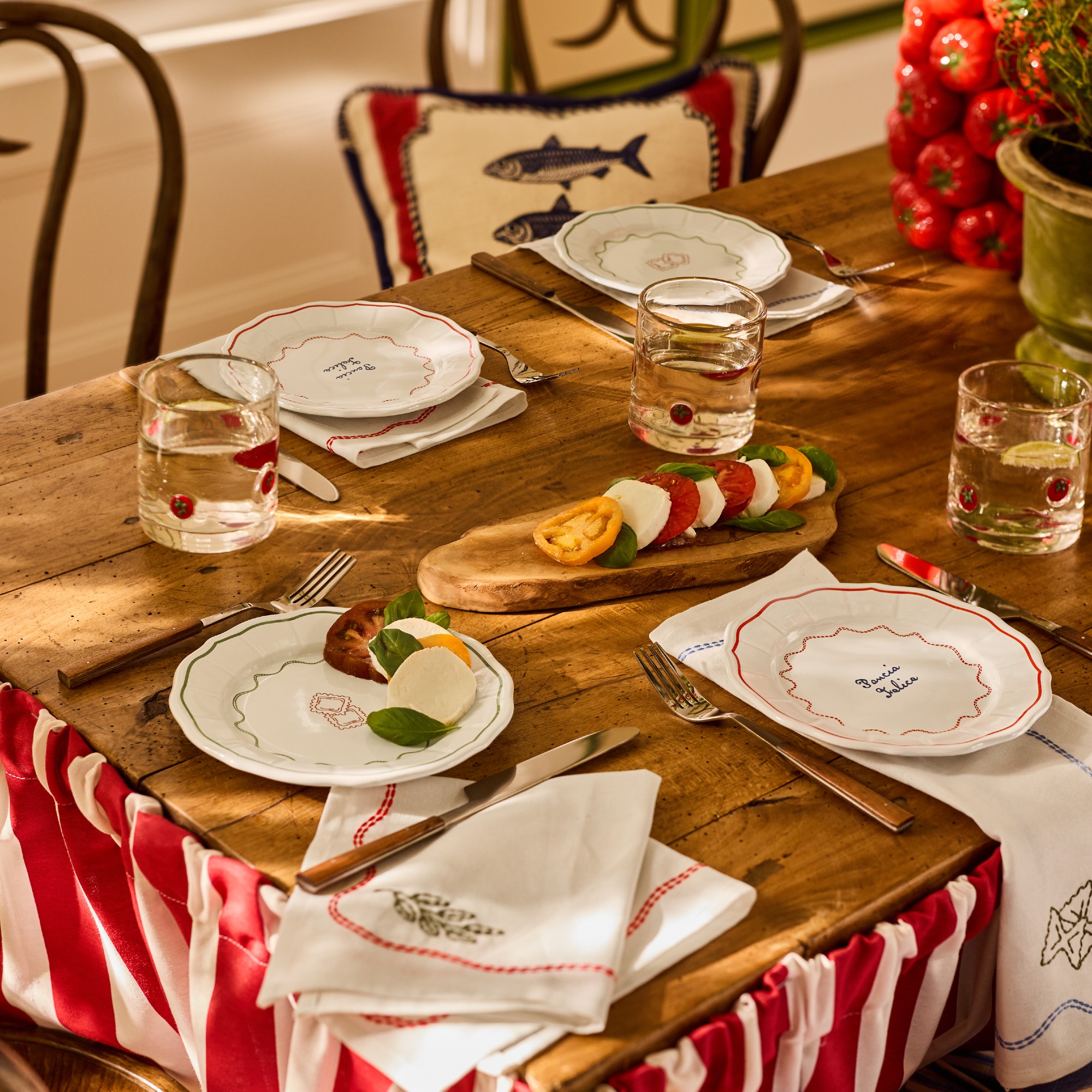 A rustic dining table with side plates and napkins from Lia Gold's collection for Next