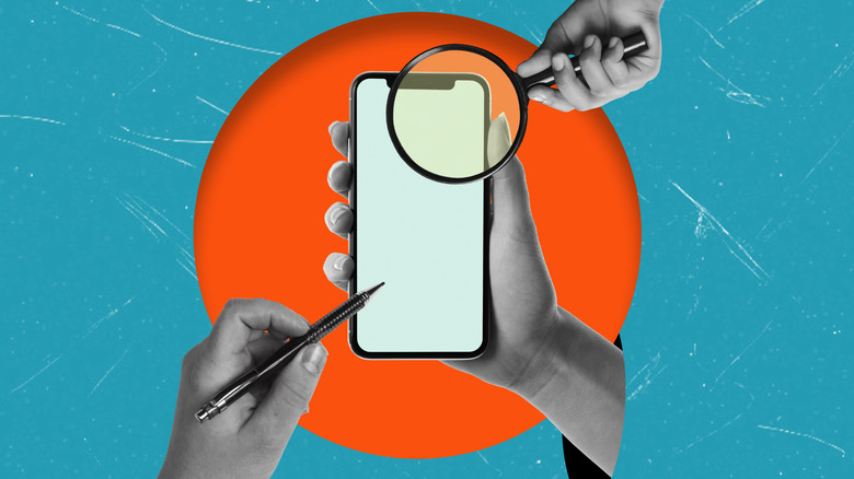 Phone in hand with pen and magnifying glass with blue and orange background