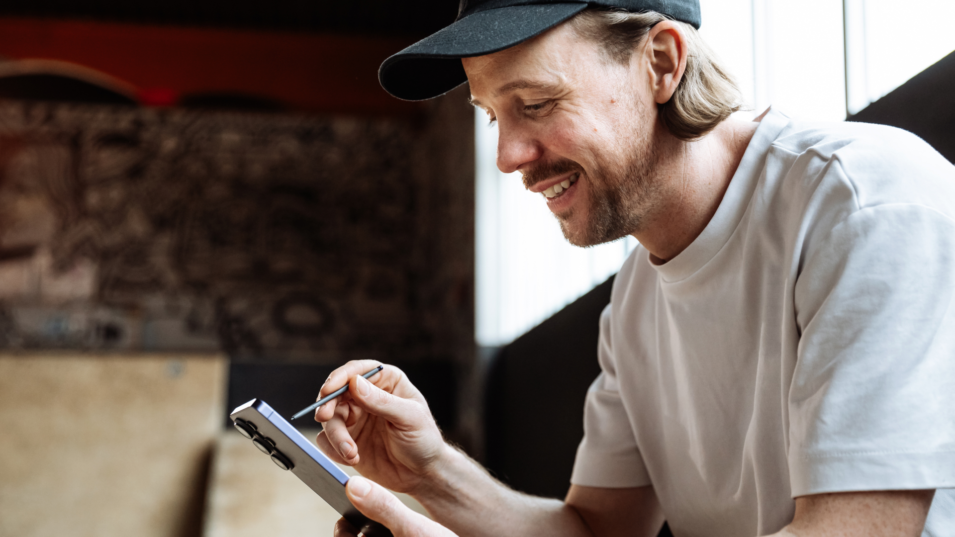 A man editing images using a stylus on the Samsung Galaxy S26 Ultra