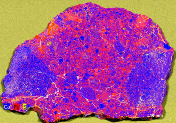 XRF map of 7.53 g slice of NWA 12593: calcium (Ca) and iron (Fe) illustrate the location and diversity of clasts; sulfur (S) highlights the location of cracks and terrestrial weathering. Image credit: Crow et al., doi: 10.1130/G54386.1.