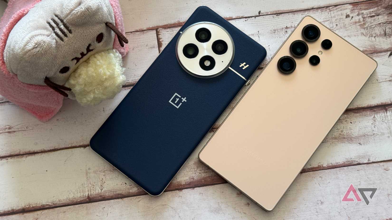 OnePlus 13 sitting next to Pusheen and a Galaxy S25 Ultra
