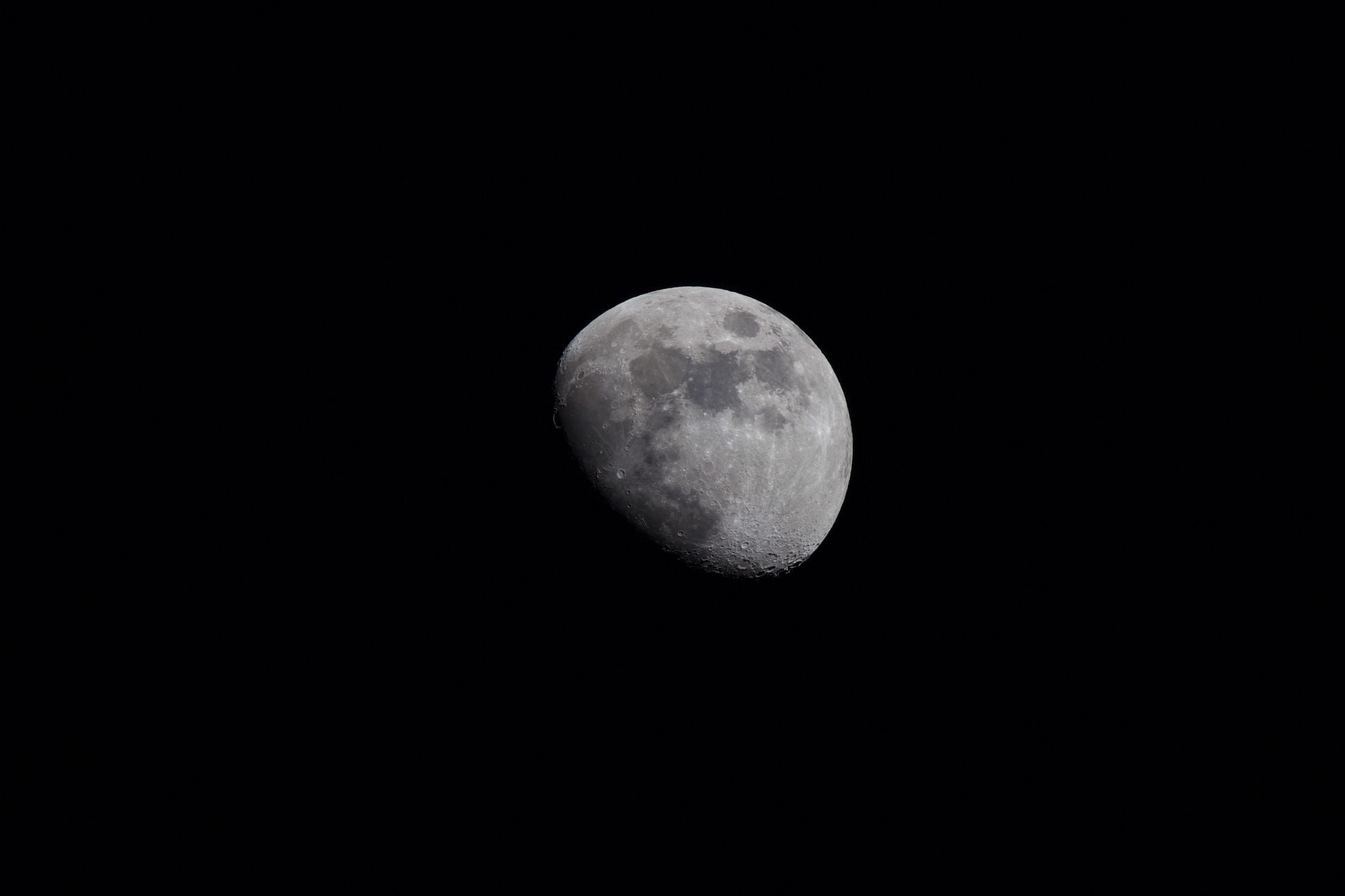 A detailed capture of the crescent moon with visible craters against a dark night sky.