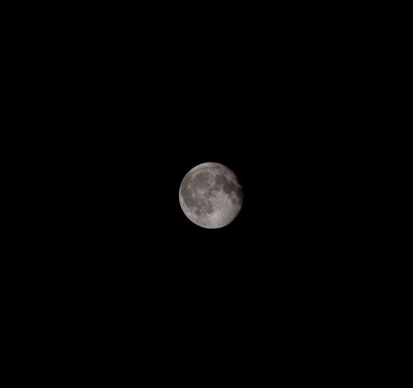 A vivid image of the full moon shining brightly against a dark night sky, showcasing its detailed craters.