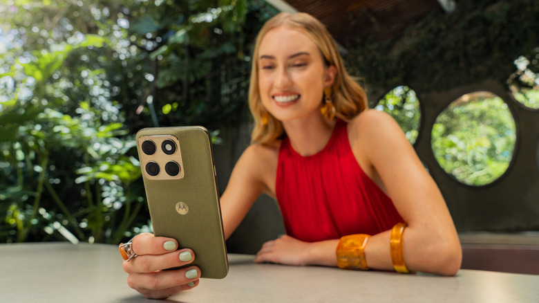 A person in red holding a phone.