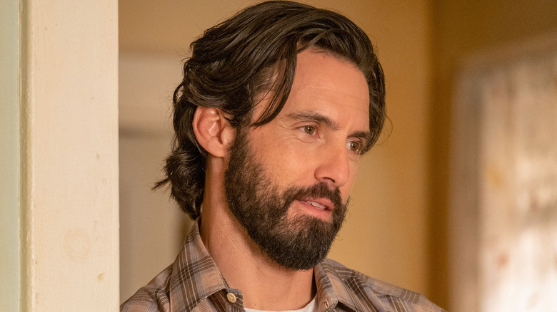 Milo Ventimiglia as Jack Pearson, smiling in a door frame in This Is Us.
