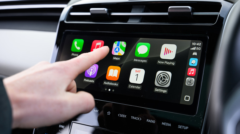 Hand Interacting with Apple CarPlay in Vehicle