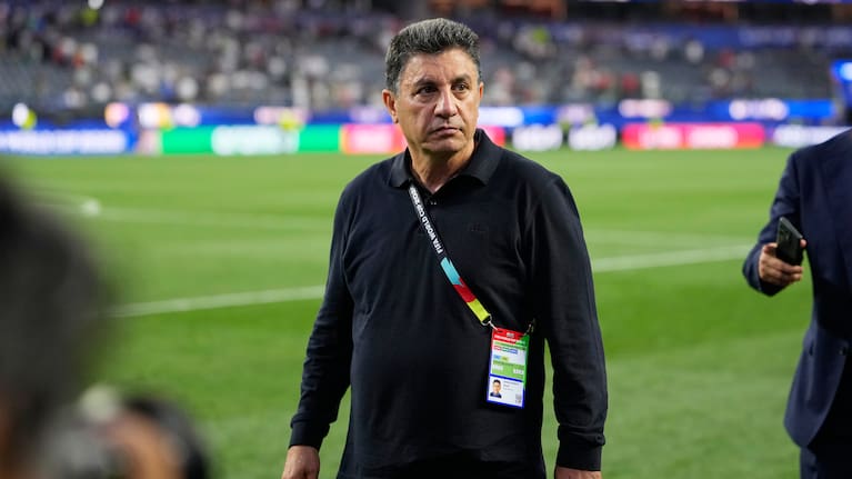 Iran head coach Amir Ghalenoei walks off the field after a draw during the World Cup Group G soccer match between Iran and New Zealand.