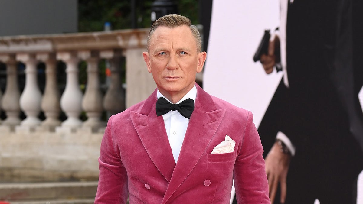 Actor Daniel Craig wearing a pink coat