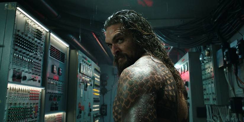 Jason Momoa as Arthur Curry, stood in a control room and looking over his shoulder in 'Aquaman' (2018)