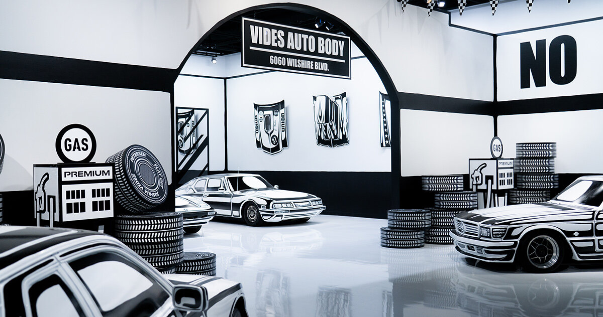 five hand-painted cars fill joshua vides' monochromatic garage at the petersen