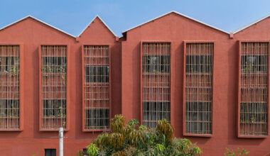underused house reconfigures into bright red preschool in india