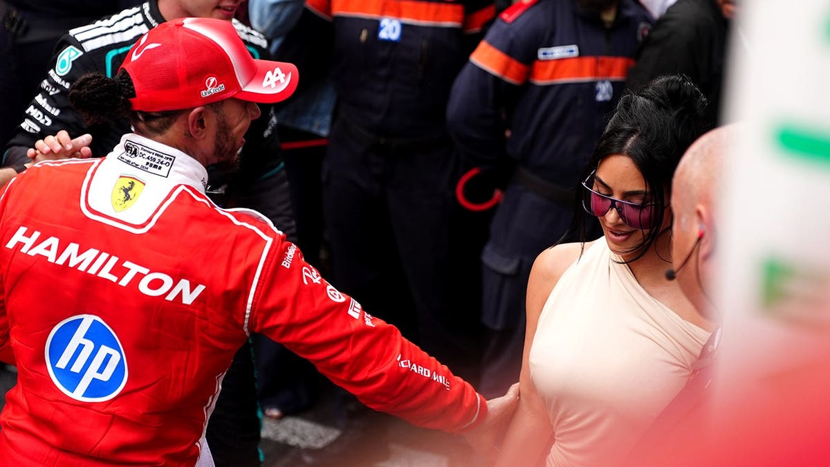 Lewis Hamilton and Kim Kardashian standing together at the Circuit de Monaco