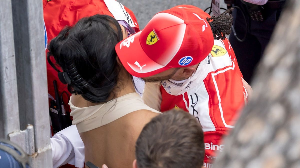Lewis Hamilton and Kim Kardashian standing together at Circuit de Monaco during F1 Grand Prix.