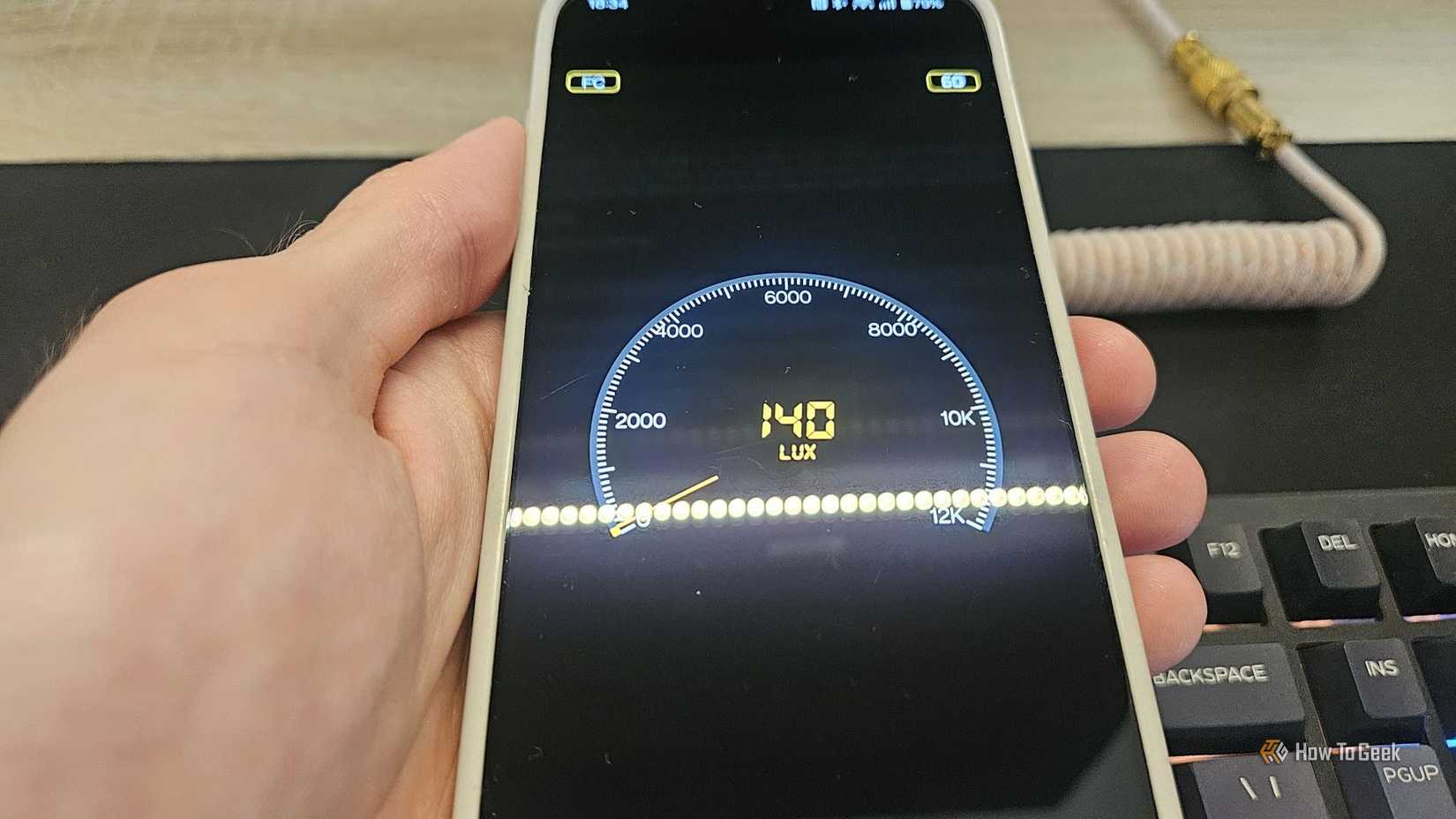 A phone measuring light, showing a luminance of 140 lux.