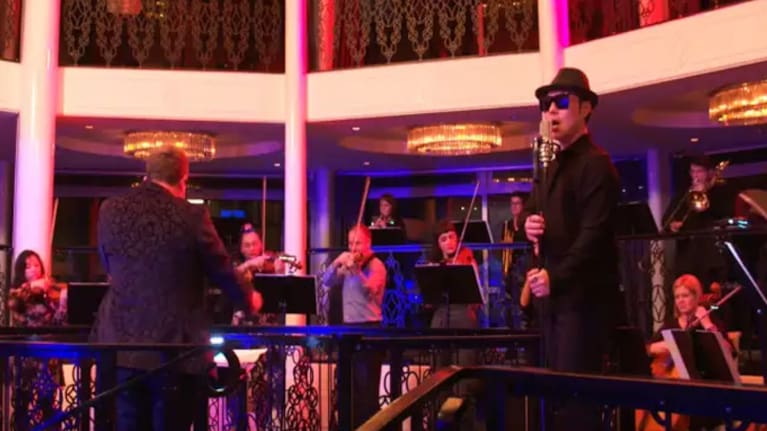  Liu and dozens of paid musicians at a recording session at a wedding venue in Northcote Point, Auckland. (Source: Screenshot / KL Music/Universe Choir)
