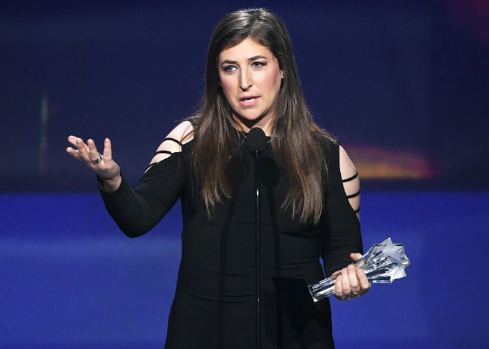 Mayim Bialik speaking at awards ceremony holding trophy Mayim Bialik speaking at awards ceremony holding trophy