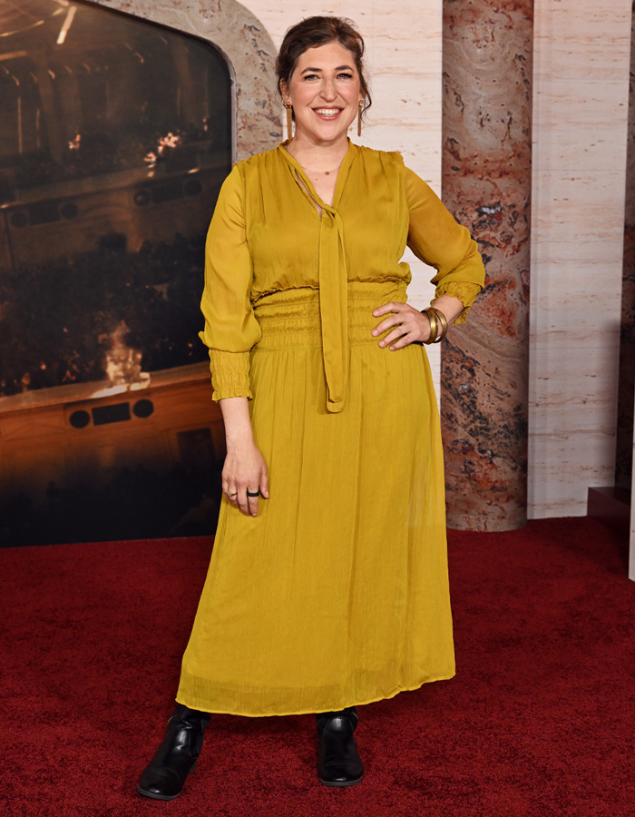 Mayim Bialik posing on red carpet in yellow dress at event Mayim Bialik posing on red carpet in yellow dress at event