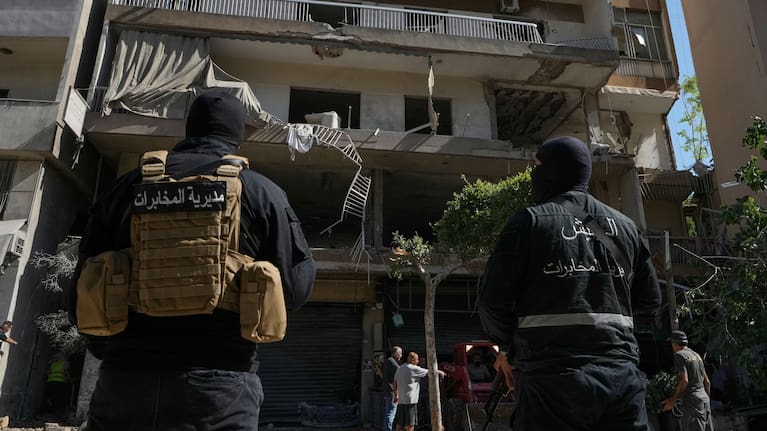 Members of the Lebanese Army Intelligence stand guard in front of an apartment that was struck in an Israeli airstrike in Dahiyeh, Beirut's southern suburbs, Lebanon.