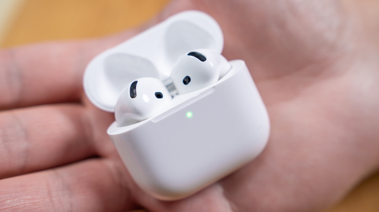Apple AirPods 4 in a person's hand