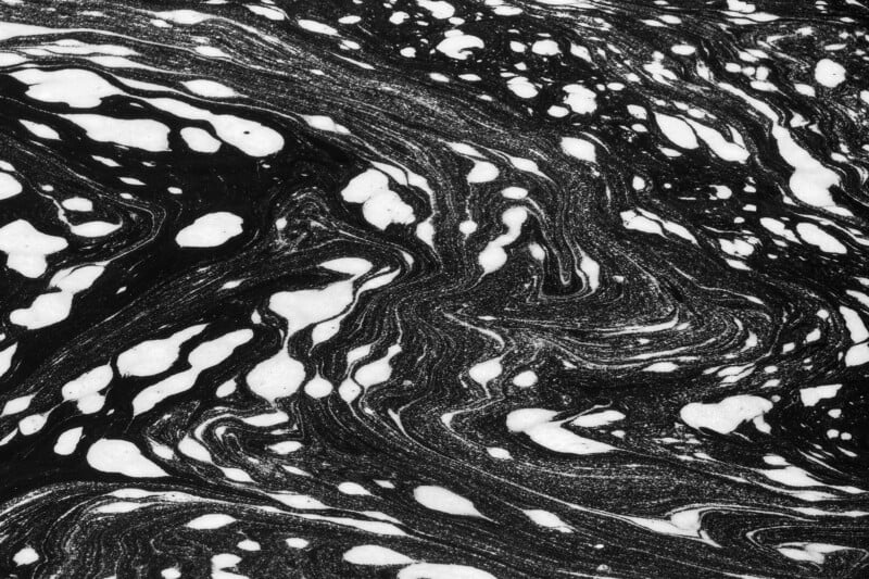 Black and white abstract pattern resembling swirling marble or ink in water