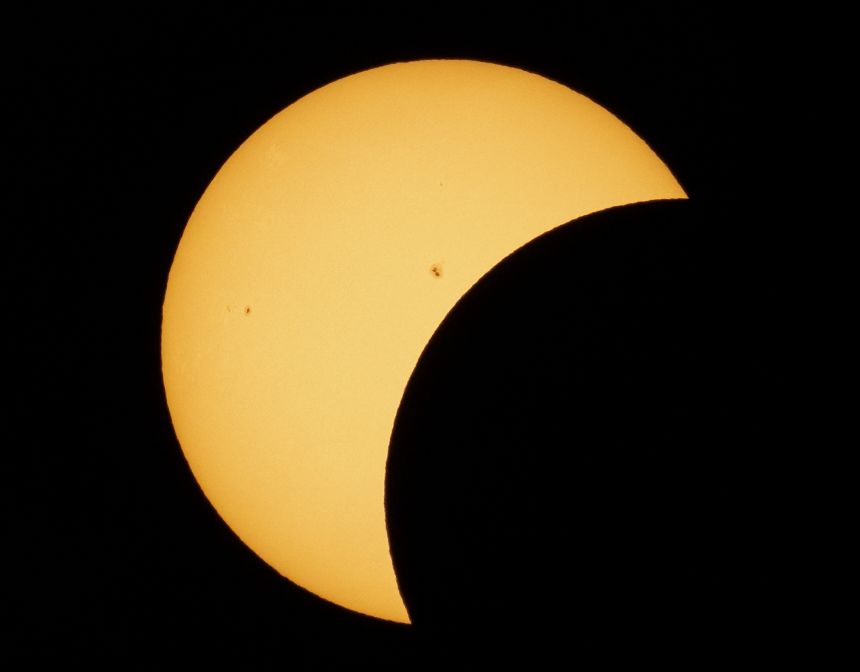 A partial solar eclipse appears in the sky over Dallas on April 8, 2024.