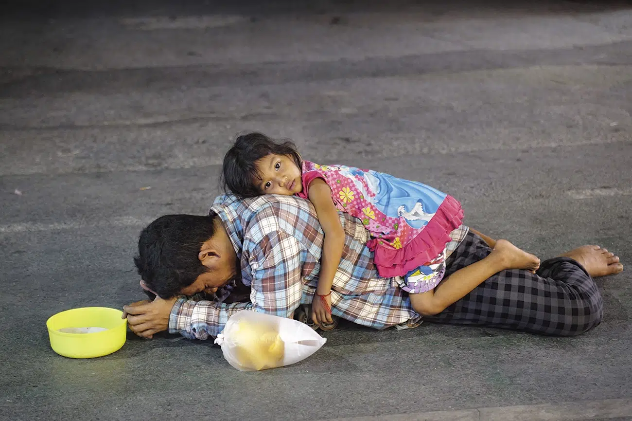 Child laying on back of father