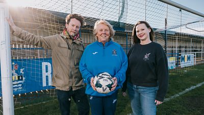 Jackie with Megson stood in the goal of a football pitch