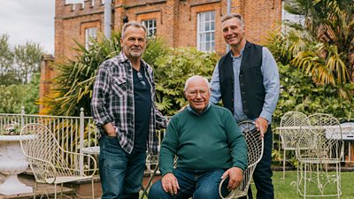 Martin Simpson with Mick and Andy Tams in the garden of a grand house
