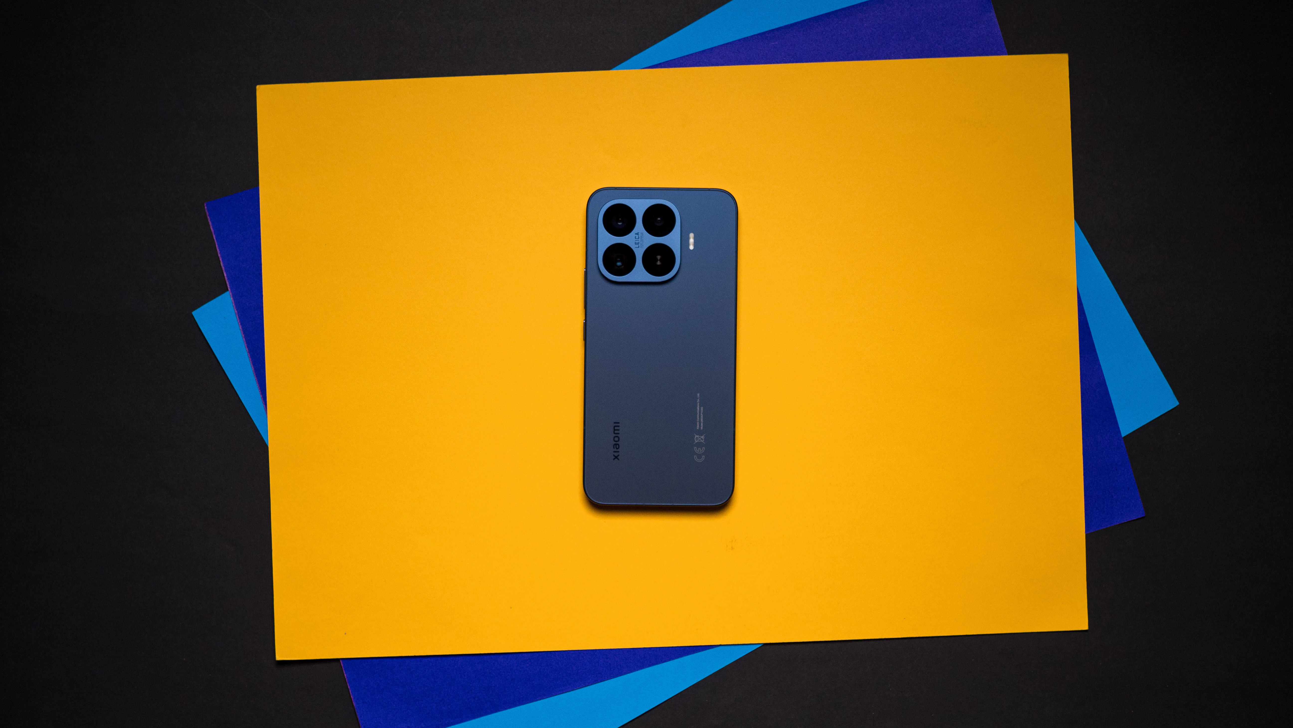 Xiaomi 17T Pro rear view against a colorful craft sheet highlighting the design