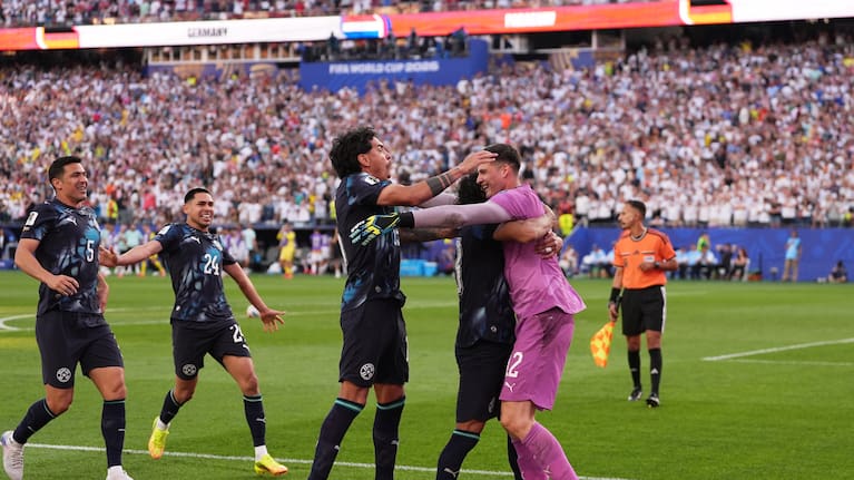 Paraguay players celebrate with Paraguay goalkeeper Orlando Gill, right, after winning the World Cup round of 32 match between Germany and Paraguay in Foxborough. 