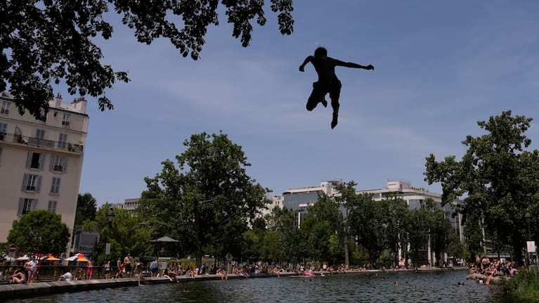 Parisians bath in the Canal Saint-Martin in Paris, as the national weather service, Meteo France, placed 54 departments, about half the country, under a red heat wave alert.