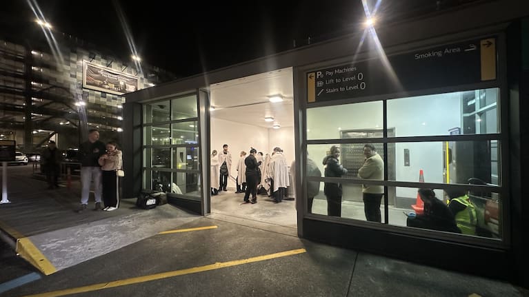 Passengers evacuate after a fire at Wellington Airport.