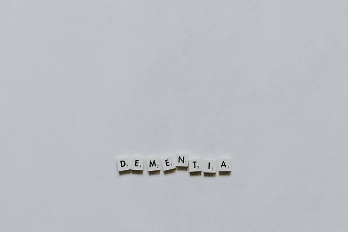 Scrabble tiles spelling dementia on white background, dementia awareness