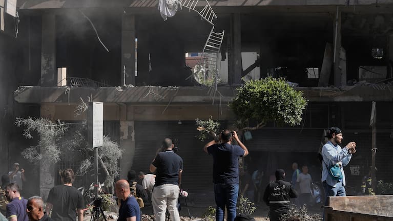People gather at the site of an Israeli airstrike that struck an apartment in Dahiyeh, Beirut's southern suburbs, Lebanon.