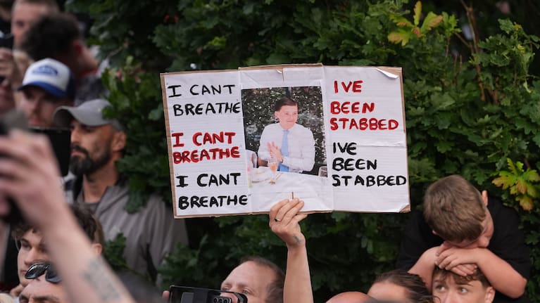 People protest outside the police station in Southampton, England, on Tuesday, June 2, 2026, one holding a photo of December 2025 stabbing victim Henry Nowak, 18.