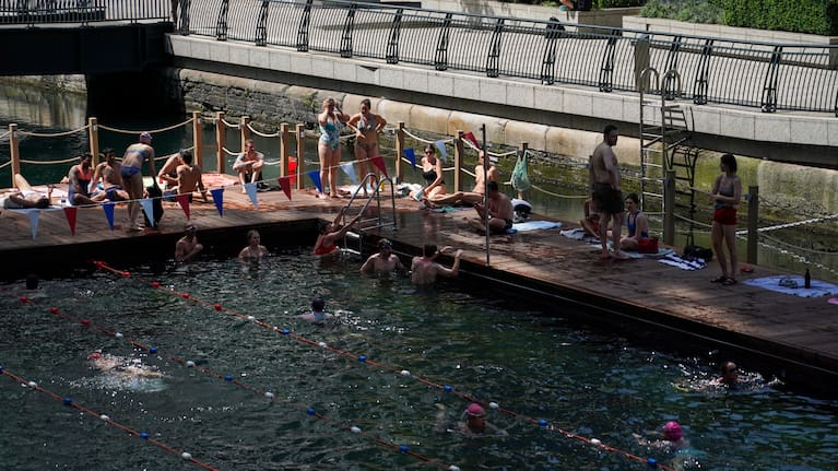 People swim in an outdoor swimming pool in London, Tuesday, June 23, 2026 as a heat wave is predicted across Britain.