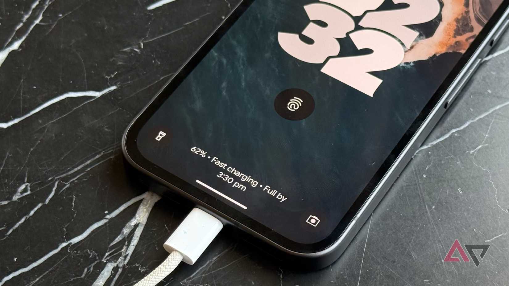 Android smartphone Google Pixel 9a resting on a table while charging