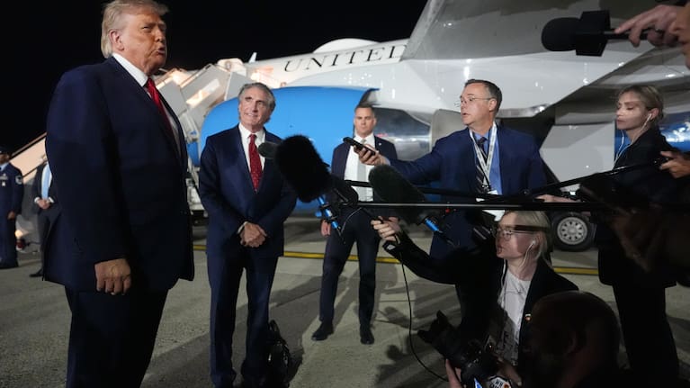 President Donald Trump talks with reporters before boarding Air Force One at John F. Kennedy International Airport in New York.