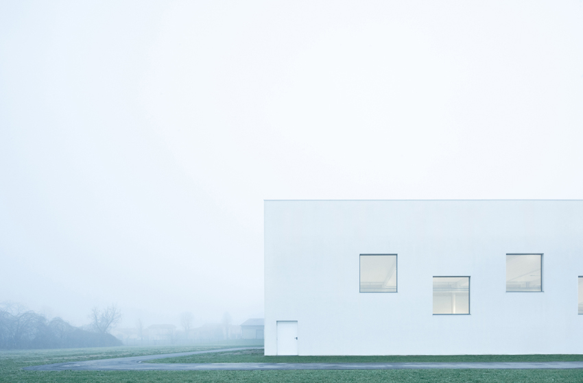 vertical white pillars compose rhythmic facade enfolding primary school in italy - 2