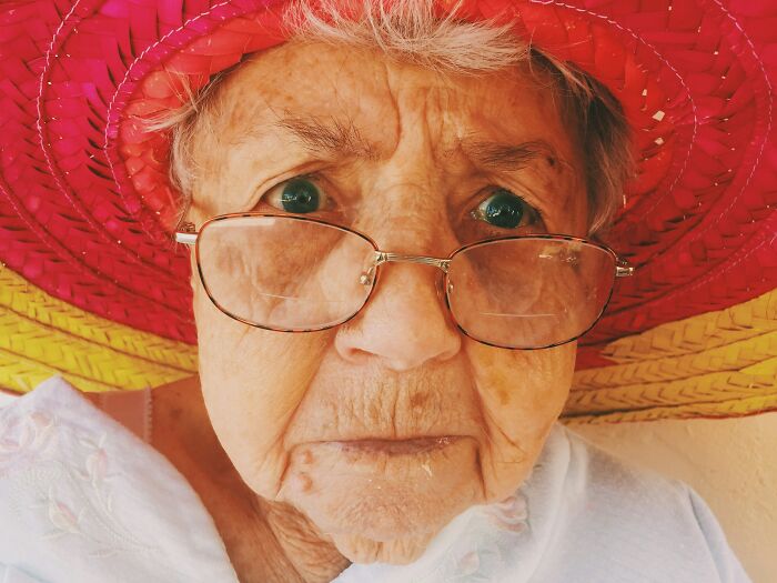 Elderly woman wearing hat close-up dementia care expert photo