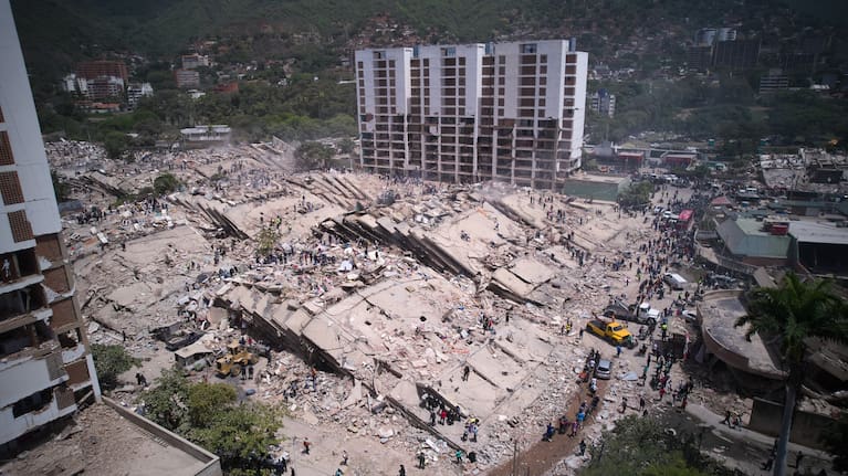 Residents and rescue workers search through the rubble two days after an earthquake struck La Guaira, Venezuela, Friday, June 26, 2026.