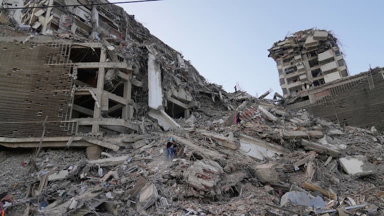 Residents search through the rubble two days after an earthquake struck La Guaira, Venezuela