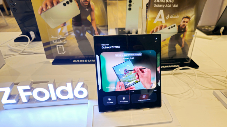 Samsung Galaxy Z Fold6 on showroom floor nest to lit display with name