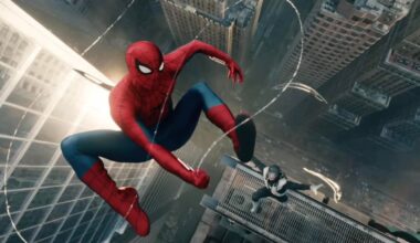 Spider-man flies through the air high above an urban canyon