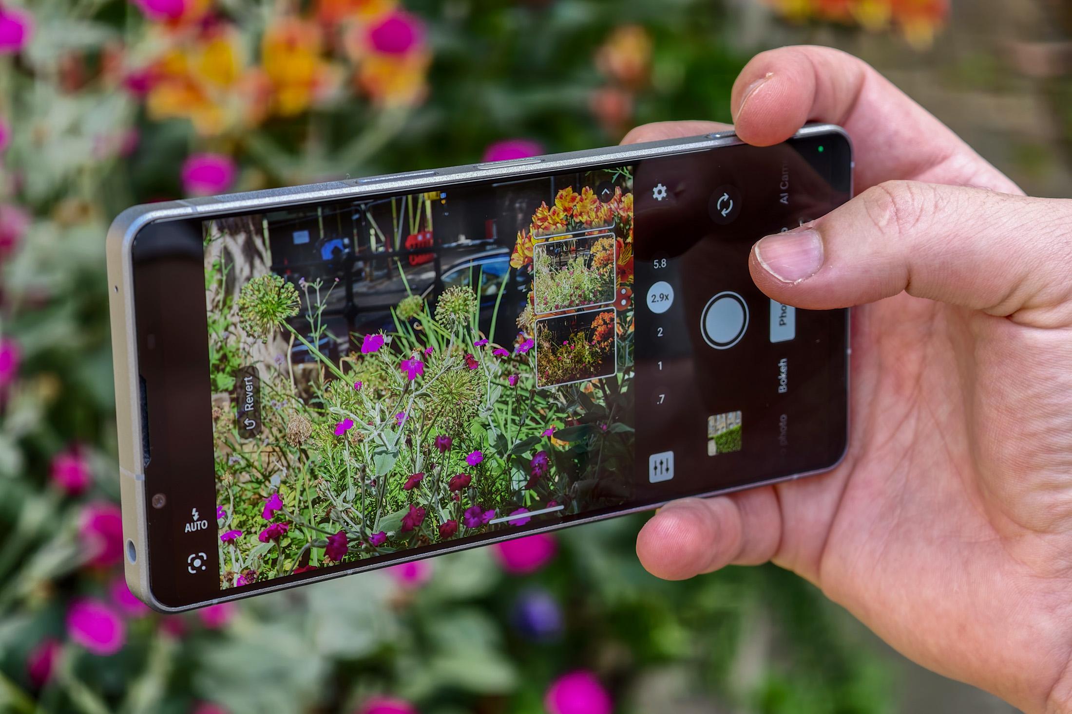 Photo of the Sony Xperia 1 VIII in front of flowers, showing the AI Camera Assistant