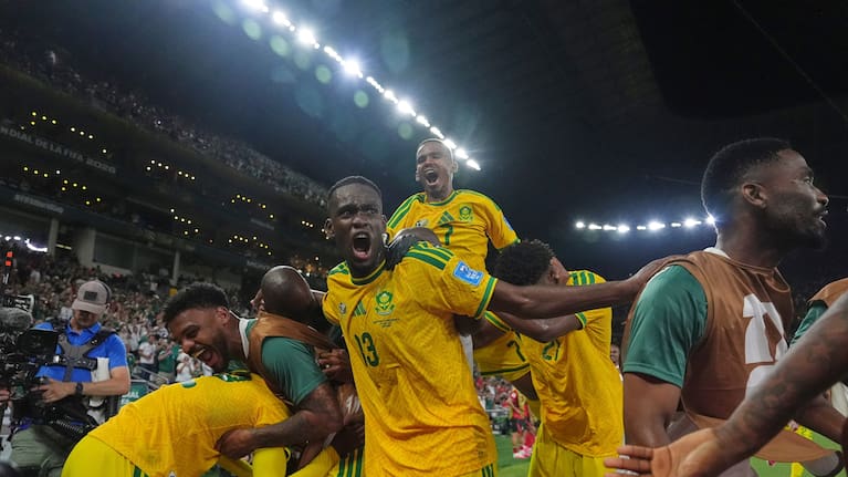 South Africa's Thapelo Maseko (12) celebrates with teammates after scoring his side's first goal during the World Cup Group A match between South Africa and South Korea in Guadalupe. 