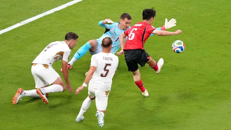 South Korea's Hwang In-beom, right, shoots and scores a goal against Czechia goalkeeper Matej Kovar.