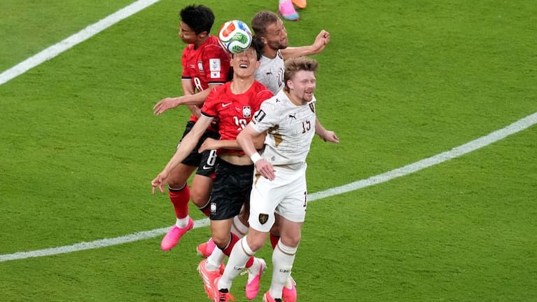 South Korea's Lee Jae-sung, center, heads the ball against Czechia's Tomas Soucek (22) and Pavel Sulc (15).